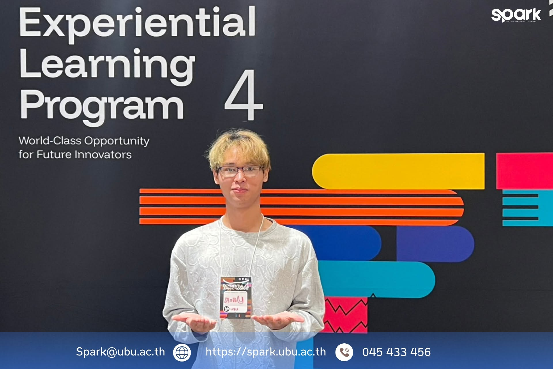 Participant in front of the Experiential Learning Program 4 backdrop